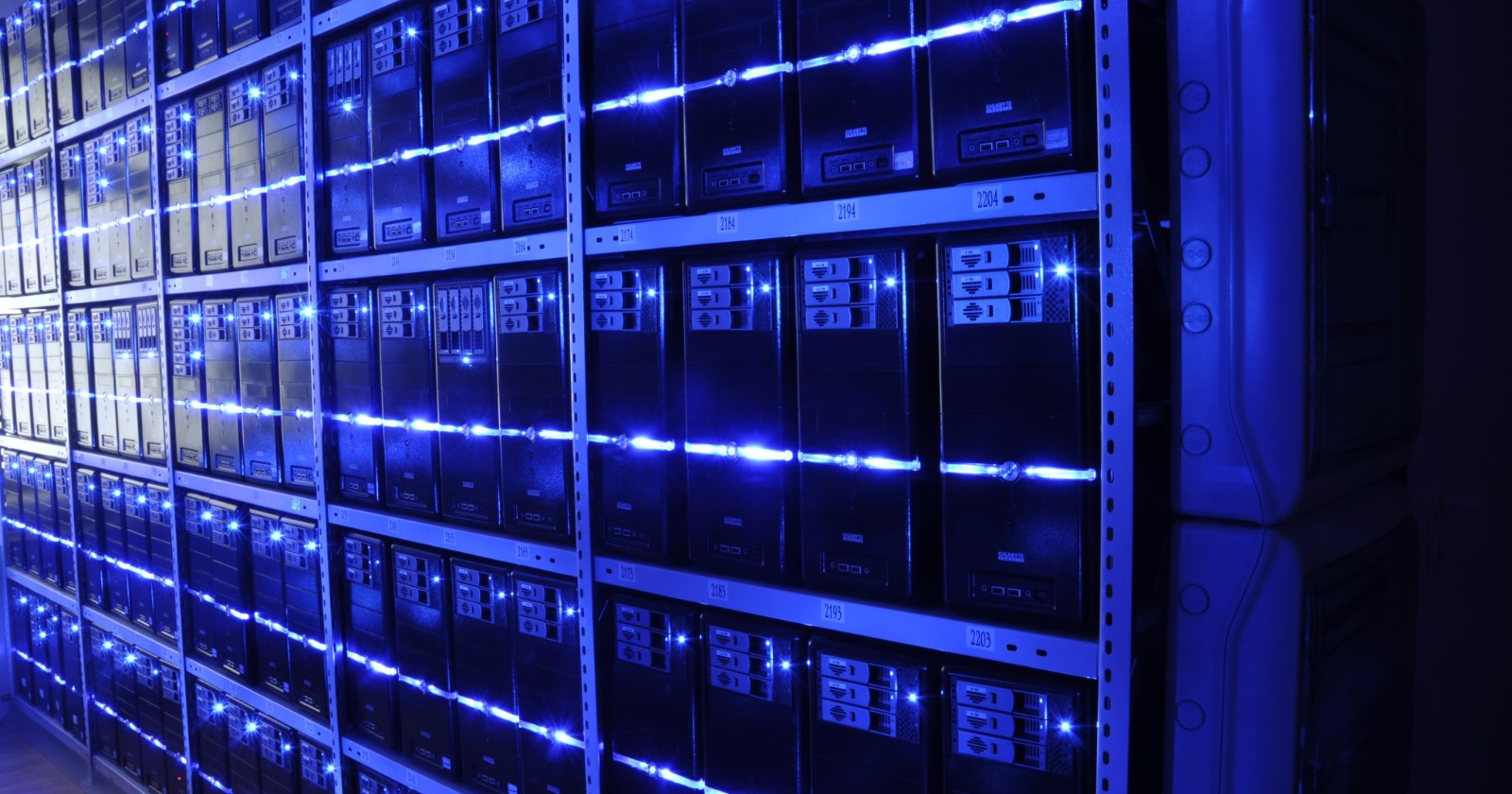 Rows of illuminated server racks in a data center aisle