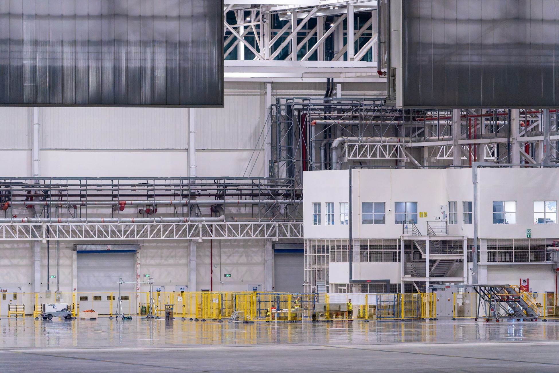 Spacious modern factory interior showcasing industrial manufacturing machinery.