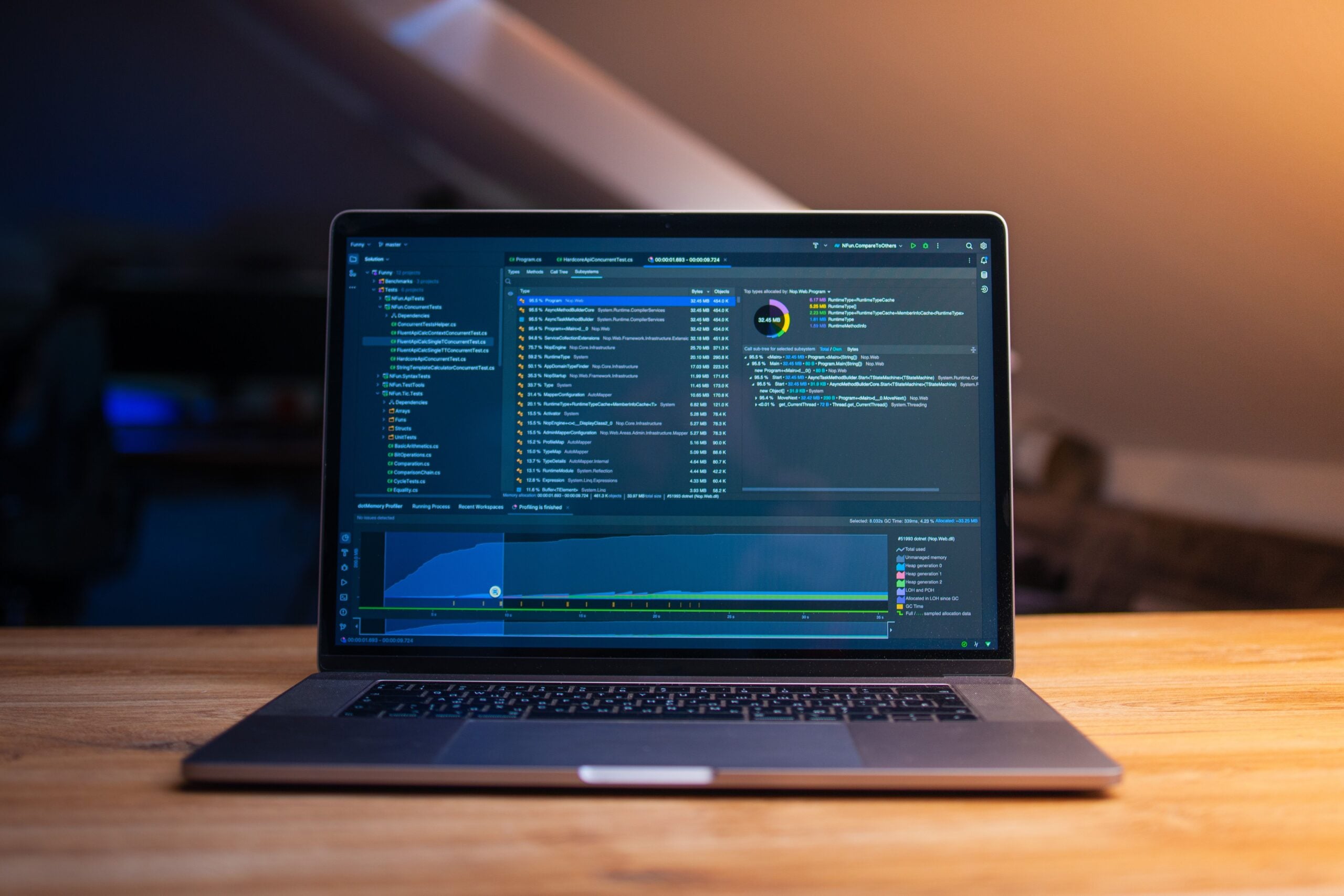 A laptop displaying code on a desk in a dimly lit workspace, representative of AI-assisted software development