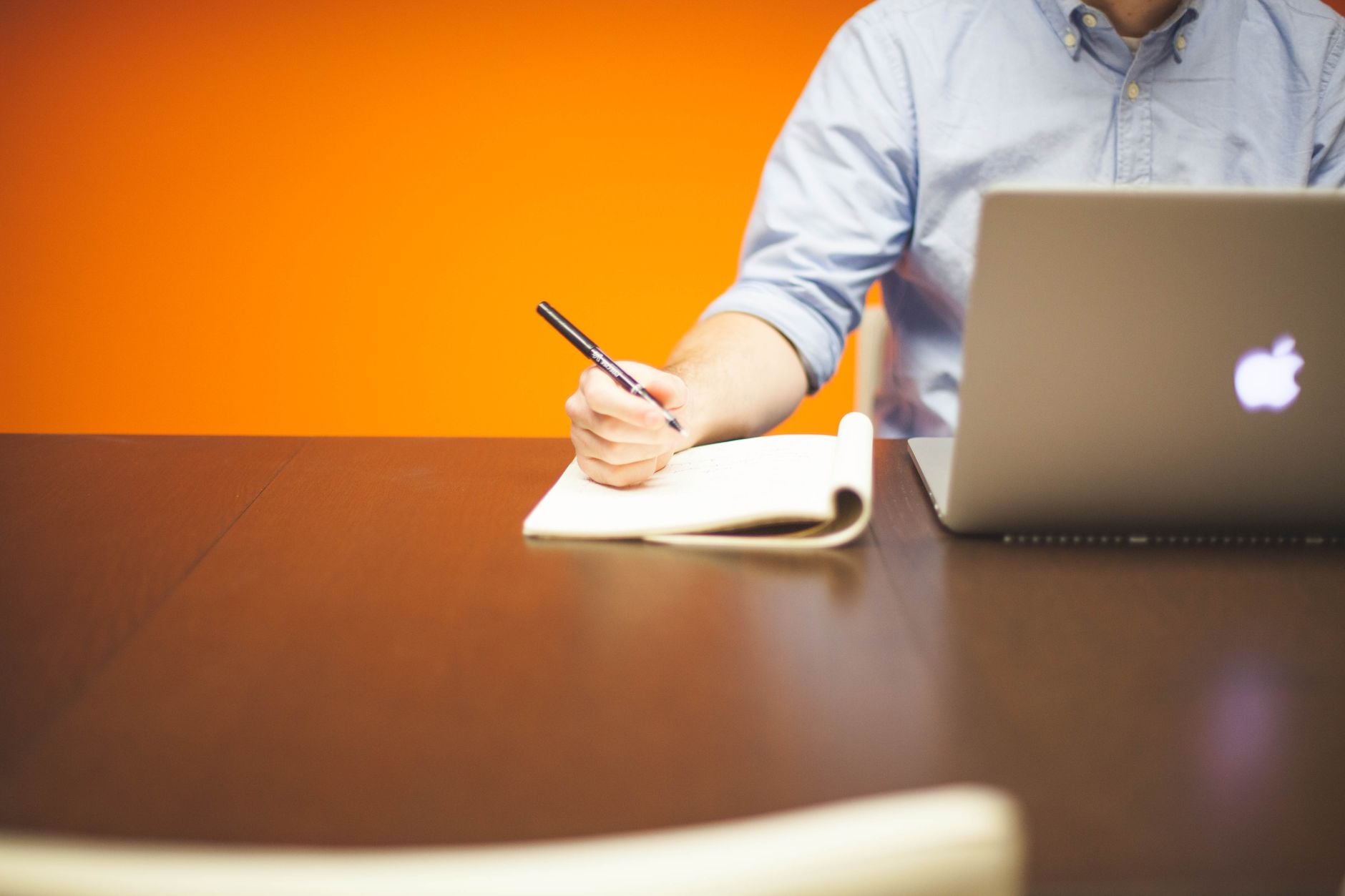 Representative notebook beside a laptop on a desk