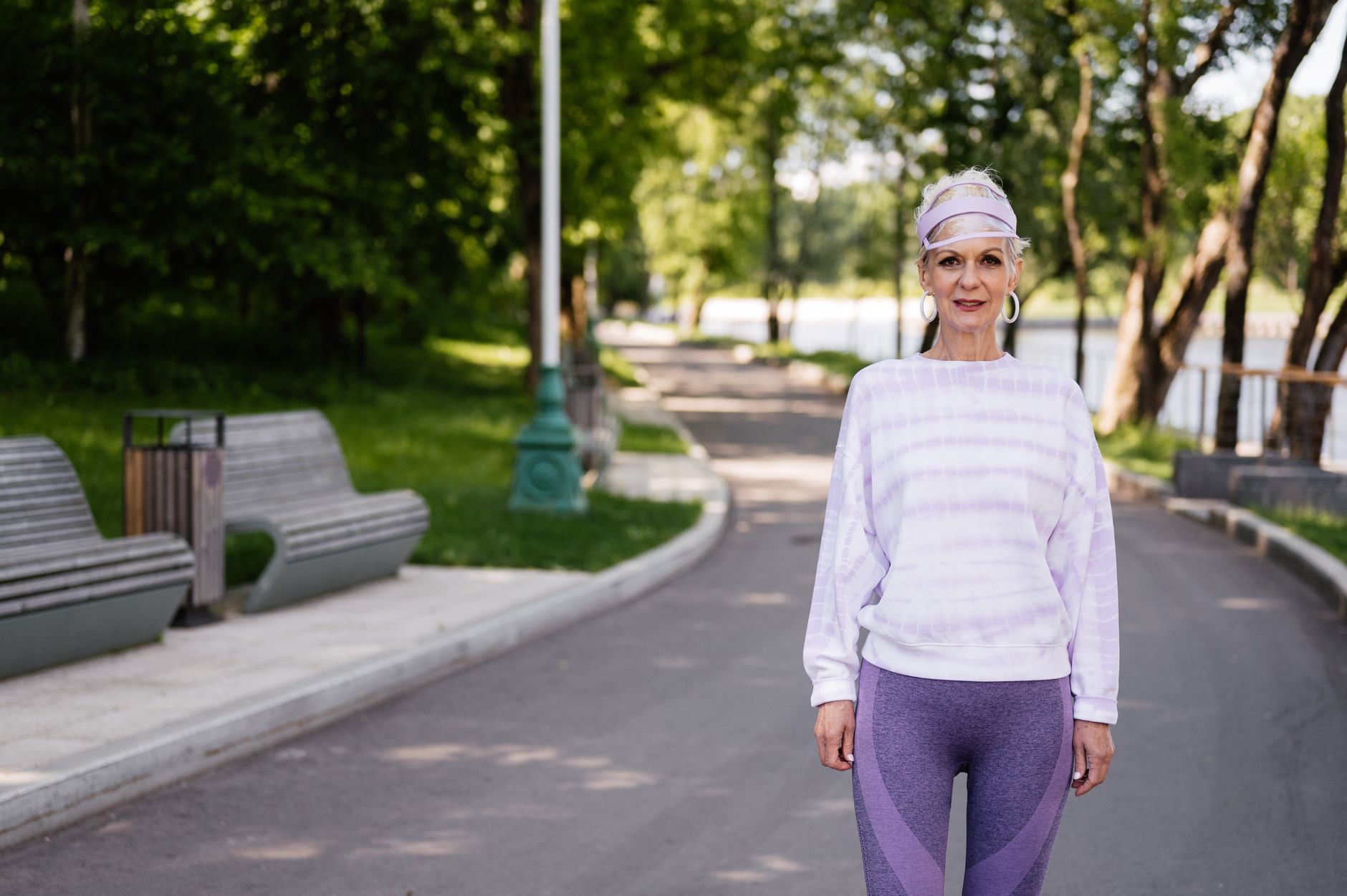 An older adult walking calmly outdoors in natural light