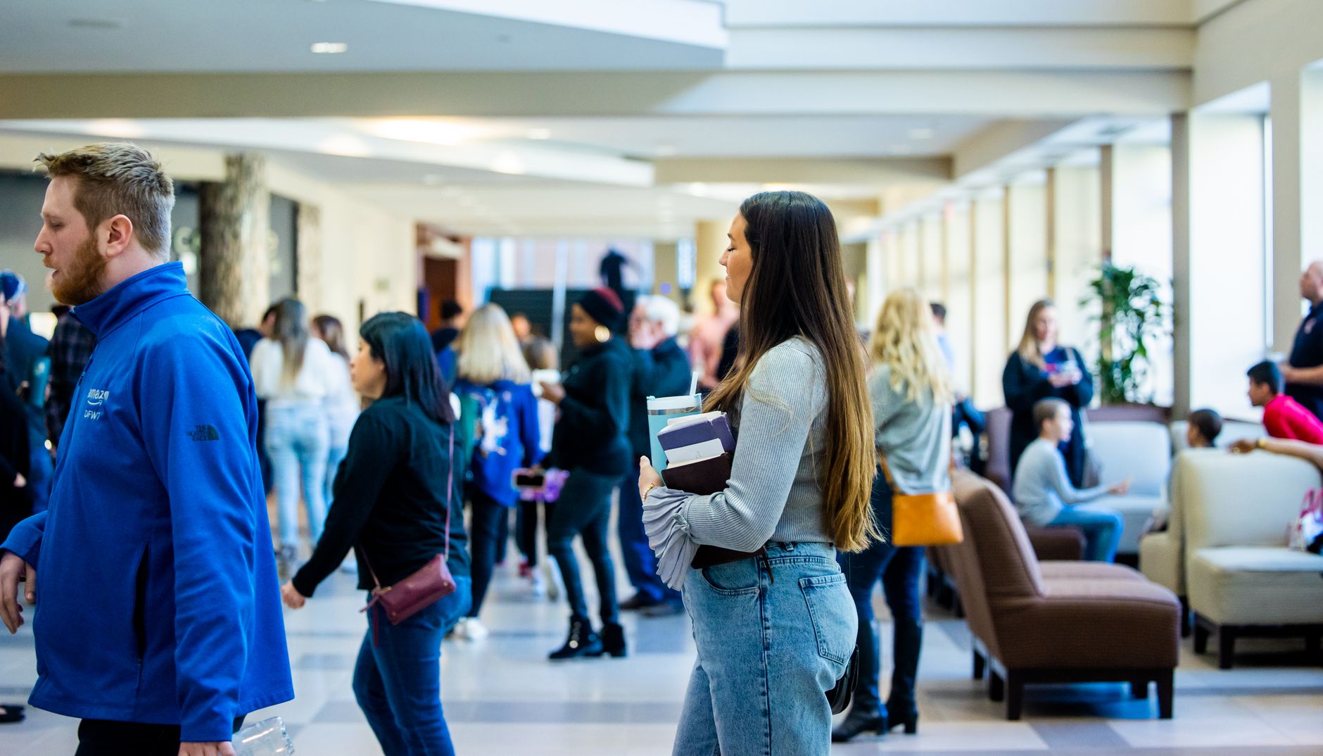Students moving through a busy university hallway