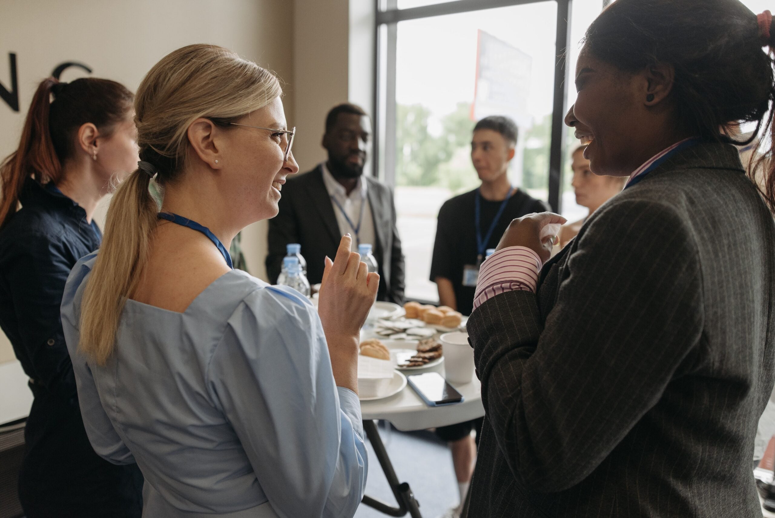 Colleagues talking over coffee at a work event
