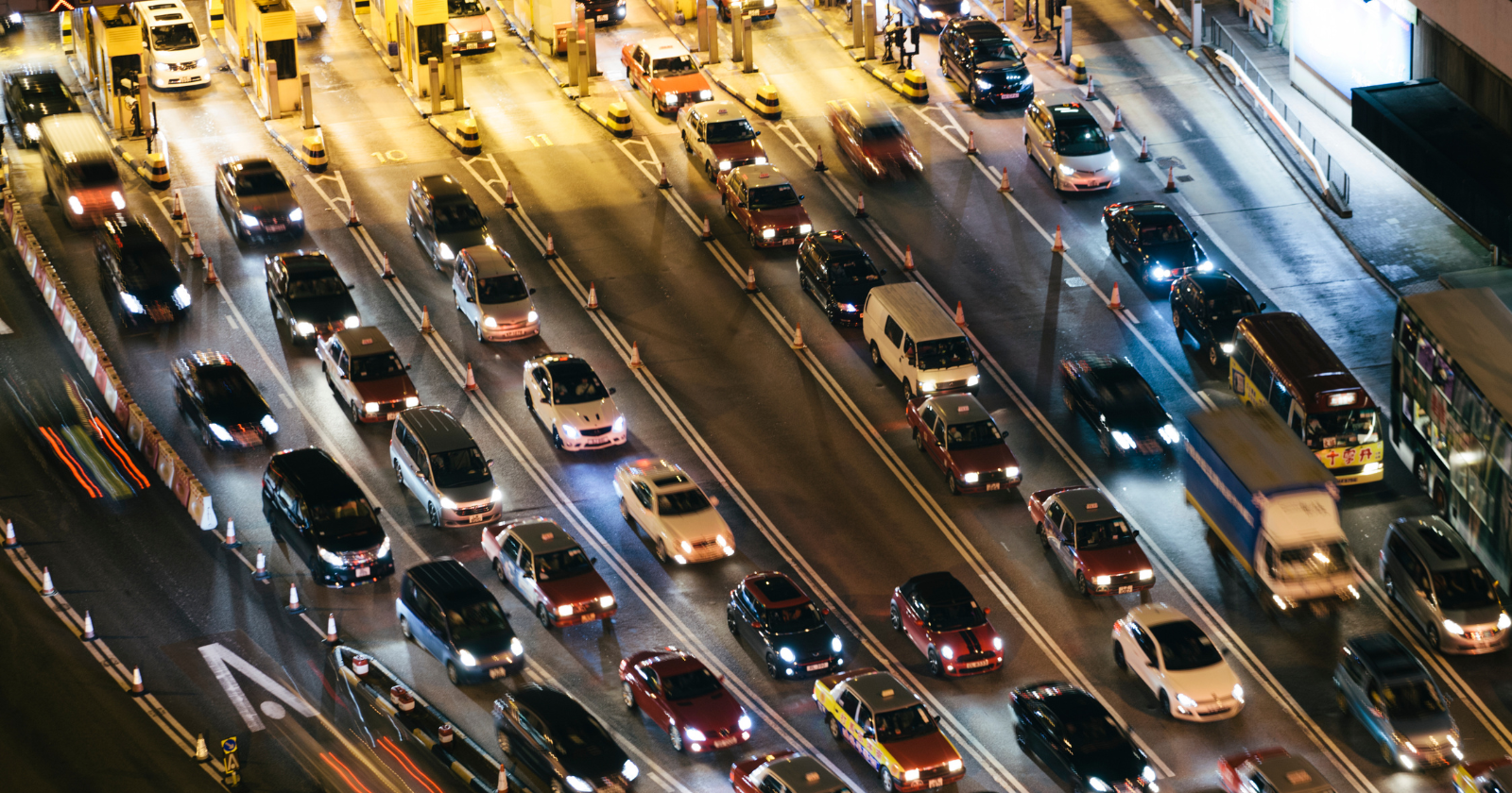 Night traffic moving through multiple toll lanes