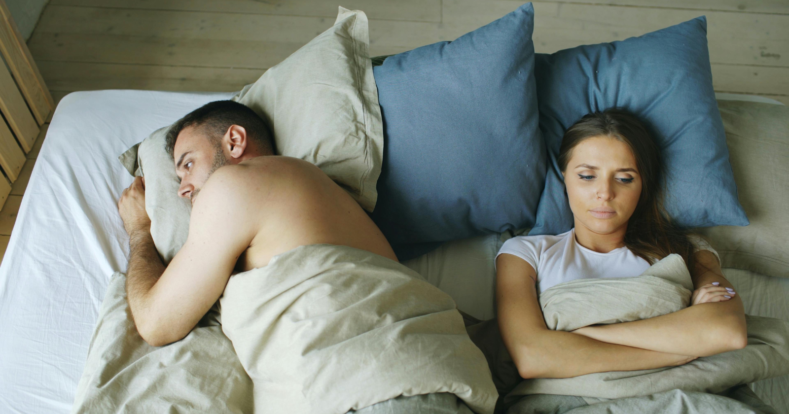 Couple lying awake in bed