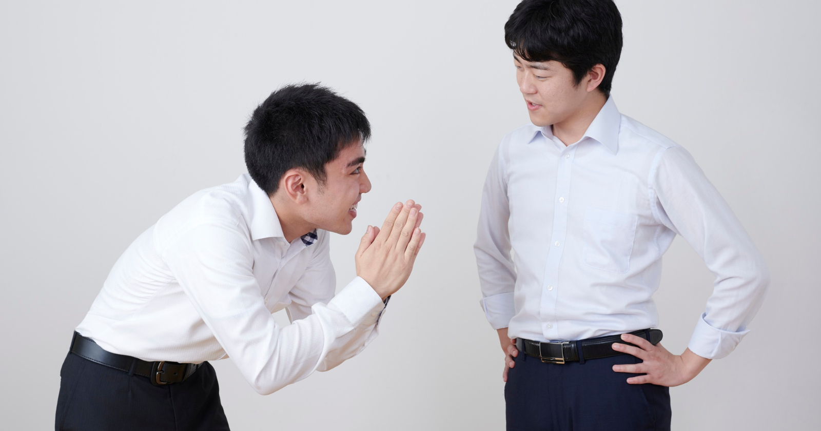Man kneeling with hands clasped in front of another man
