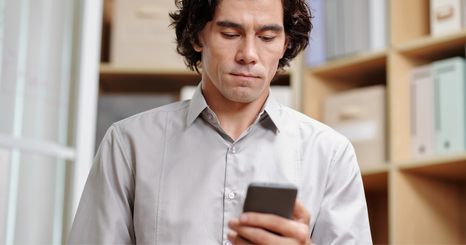Man looking down at a smartphone