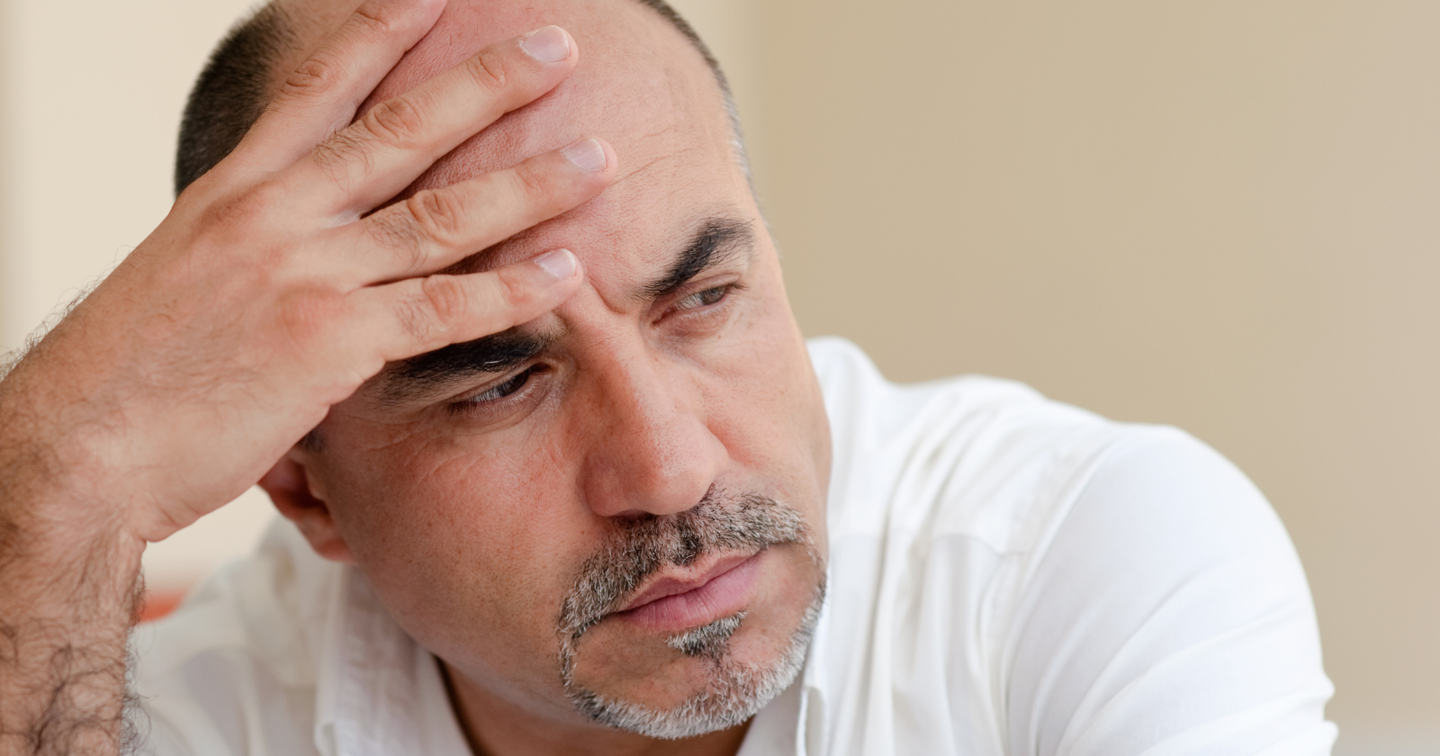 Worried middle-aged man with his hand on his forehead