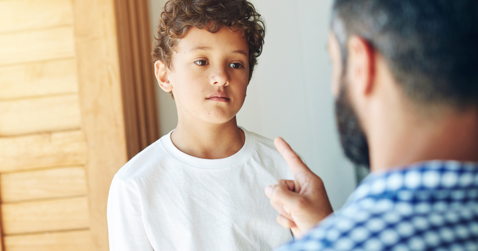 Boy being scolded by an adult