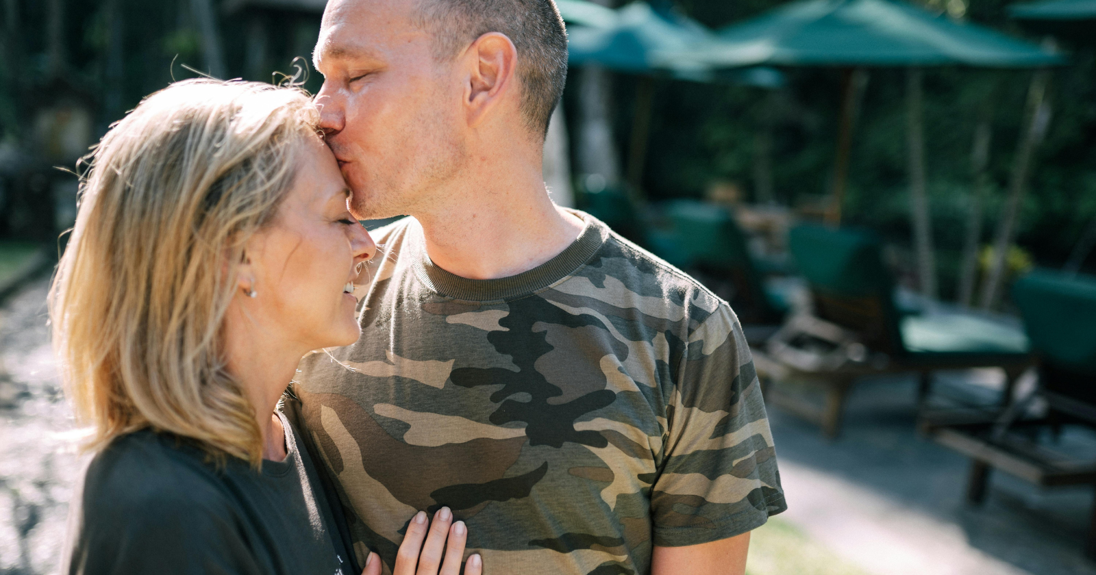 Man kissing a woman on the forehead