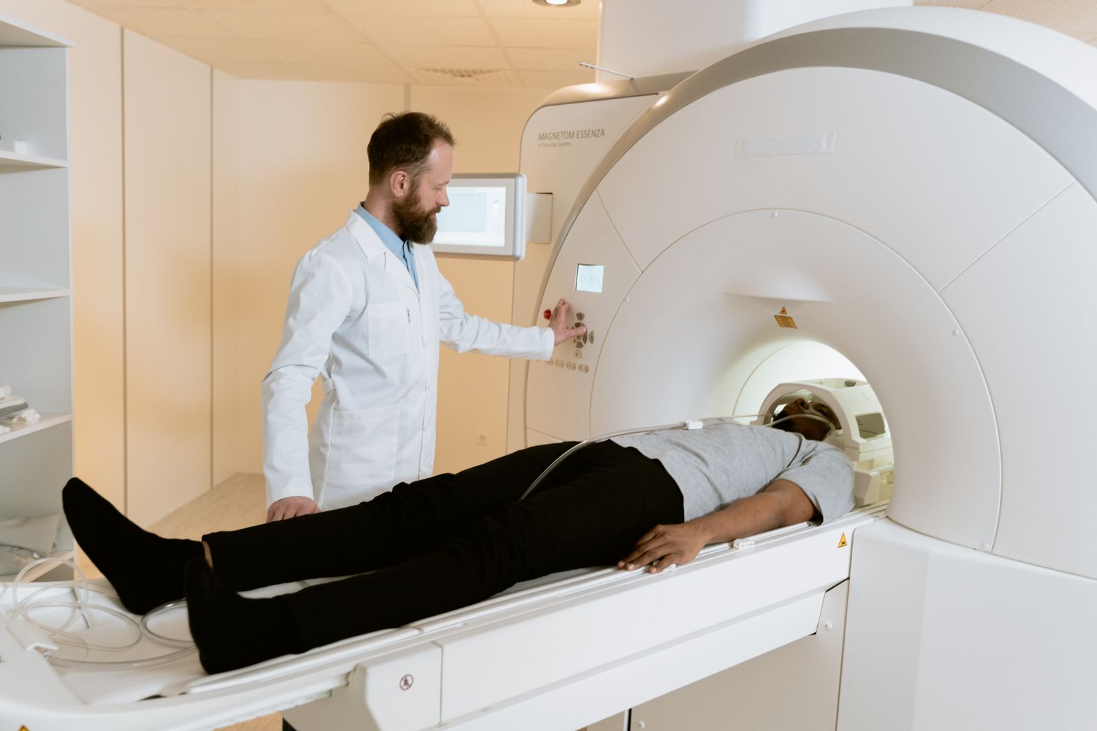 A researcher operating an MRI scanner while a participant lies inside