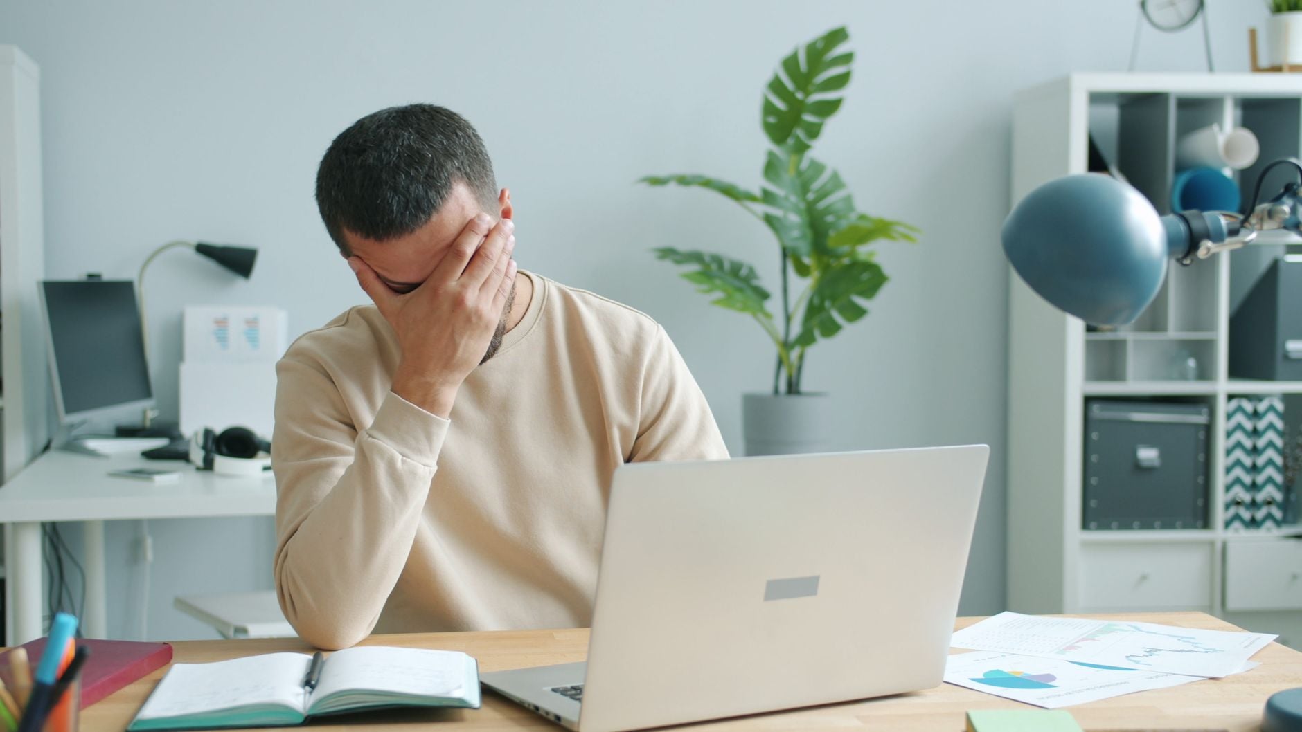 Stressed man working at a laptop