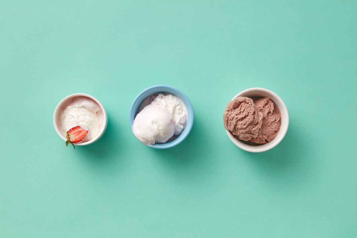 Three bowls of ice cream on a mint green background